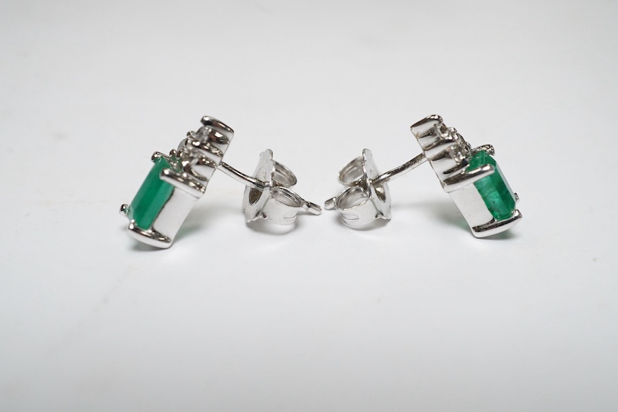 A small modern pair of 14k white metal, emerald and diamond cluster set ear studs, 9mm, gross weight 1.4 grams. Condition - good